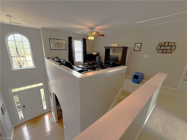 living room with visible vents, ceiling fan, a wealth of natural light, and attic access