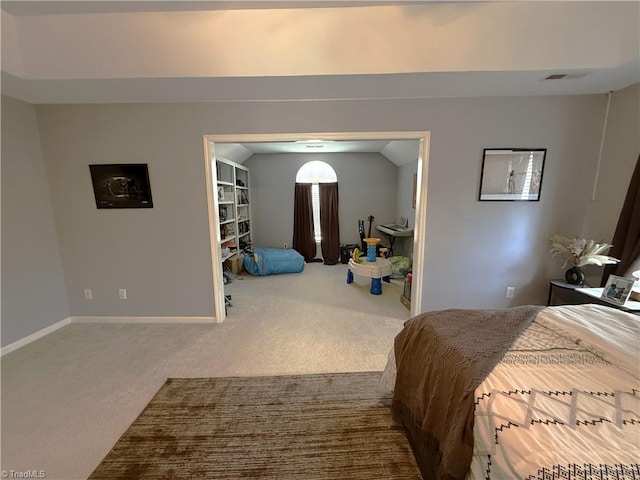 bedroom featuring lofted ceiling, carpet floors, visible vents, and baseboards