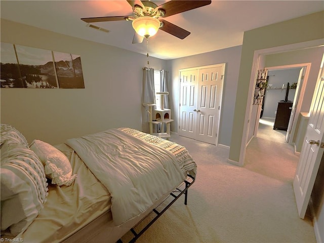 bedroom featuring a closet, visible vents, ceiling fan, and carpet flooring