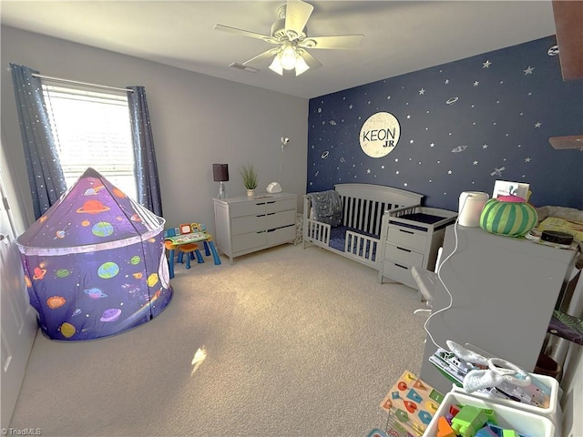 carpeted bedroom featuring ceiling fan, visible vents, and wallpapered walls