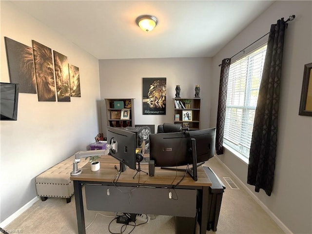 carpeted office space featuring visible vents and baseboards