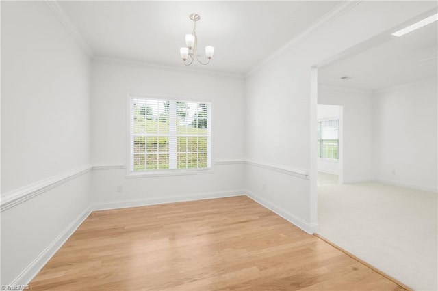 6924 Langdon Village Ct, Clemmons, NC 27012 - spare room featuring a chandelier, healthy amount of natural light, crown molding, and light wood-style flooring