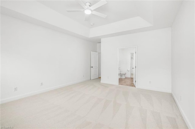 6924 Langdon Village Ct, Clemmons, NC 27012 - unfurnished bedroom featuring a raised ceiling, light colored carpet, and connected bathroom