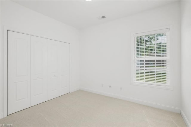 6924 Langdon Village Ct, Clemmons, NC 27012 - unfurnished bedroom featuring light carpet and a closet