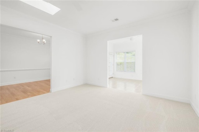 6924 Langdon Village Ct, Clemmons, NC 27012 - carpeted empty room with a chandelier, ornamental molding, and a skylight