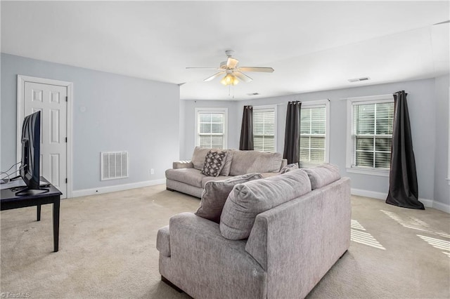 carpeted living room featuring ceiling fan