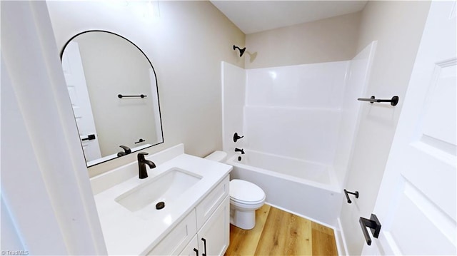 full bathroom featuring vanity, bathtub / shower combination, hardwood / wood-style floors, and toilet