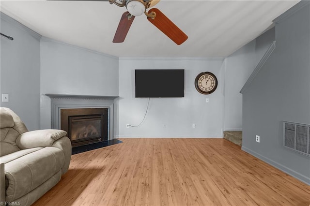 119 Tadworth Ct, Mebane, NC 27302 - living area featuring wood finished floors, ceiling fan, a fireplace with flush hearth, and ornamental molding