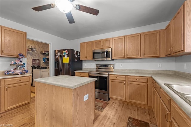 119 Tadworth Ct, Mebane, NC 27302 - kitchen featuring appliances with stainless steel finishes, light wood finished floors, a kitchen island, and a ceiling fan