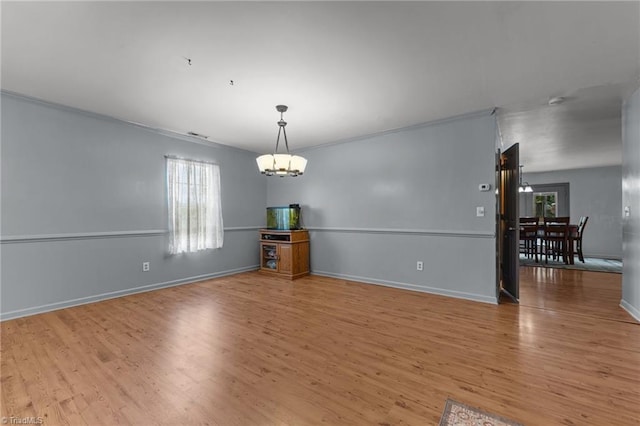 119 Tadworth Ct, Mebane, NC 27302 - spare room featuring a chandelier, wood finished floors, and crown molding