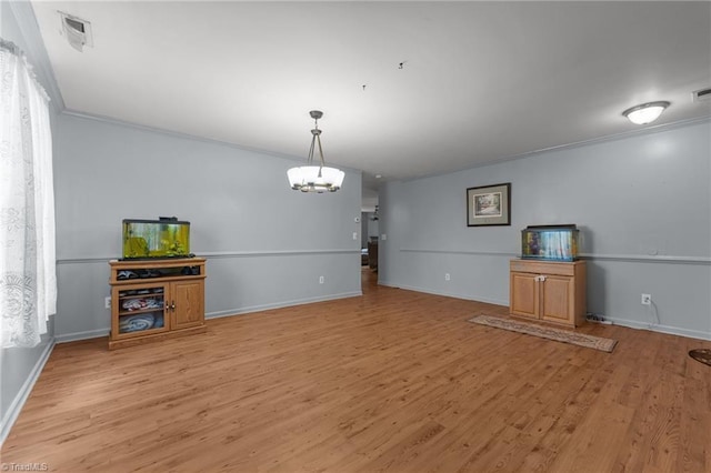 119 Tadworth Ct, Mebane, NC 27302 - unfurnished living room featuring crown molding, a chandelier, and light wood finished floors