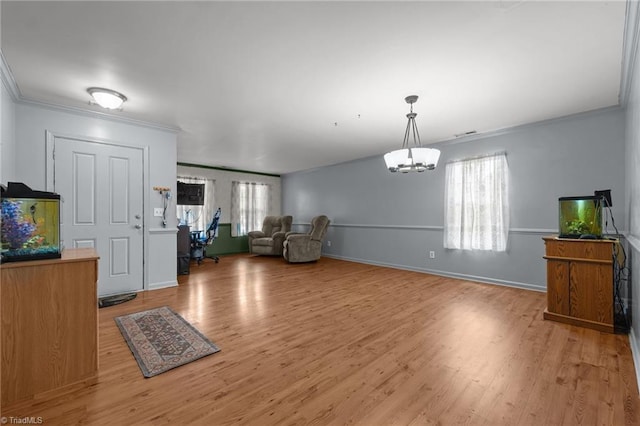 119 Tadworth Ct, Mebane, NC 27302 - unfurnished living room featuring ornamental molding, light wood-style floors, and a chandelier
