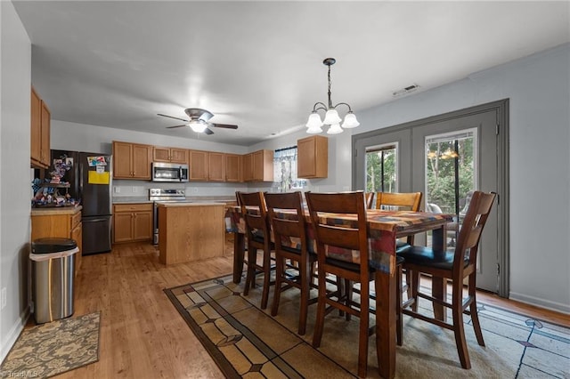 119 Tadworth Ct, Mebane, NC 27302 - dining space with light wood finished floors, a chandelier, and ceiling fan