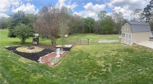 view of yard with an outbuilding and a fire pit