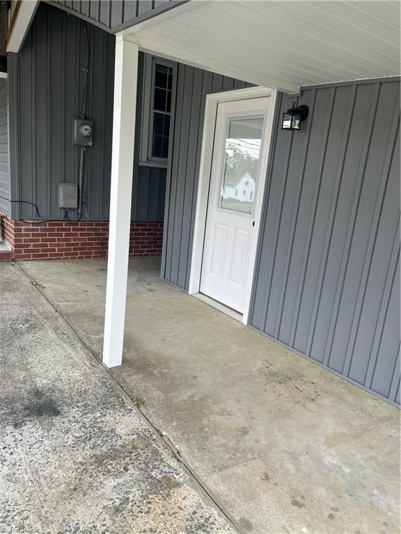 property entrance featuring board and batten siding