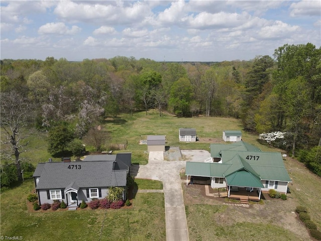 birds eye view of property with a view of trees