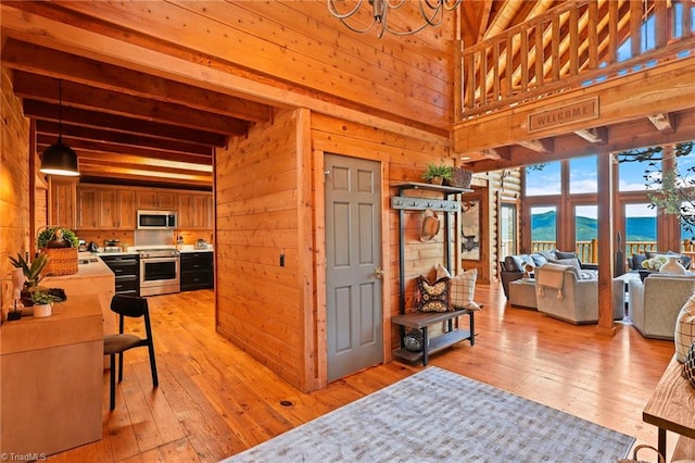 324 Sugar View Trl, Banner Elk, NC 28604 - living room with wooden walls, beamed ceiling, a water view, light wood-type flooring, and high vaulted ceiling