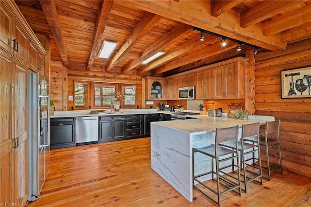 324 Sugar View Trl, Banner Elk, NC 28604 - kitchen with stainless steel appliances, rail lighting, a peninsula, light countertops, and light wood-style flooring