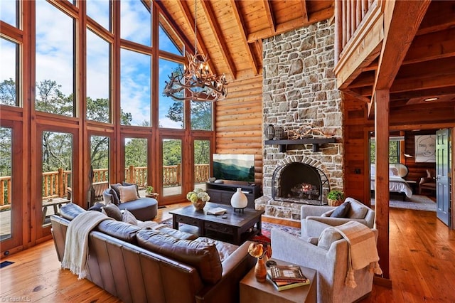 324 Sugar View Trl, Banner Elk, NC 28604 - living room with high vaulted ceiling, a wood ceiling with exposed beams, light wood finished floors, a chandelier, and a stone fireplace