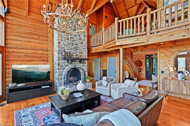 324 Sugar View Trl, Banner Elk, NC 28604 - living area featuring wooden ceiling, hardwood / wood-style floors, high vaulted ceiling, a stone fireplace, and a chandelier