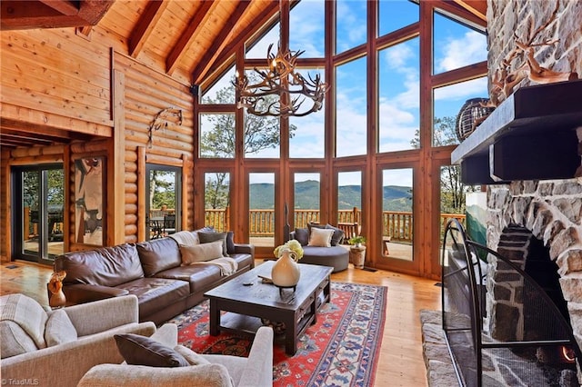 324 Sugar View Trl, Banner Elk, NC 28604 - living room with high vaulted ceiling, light wood finished floors, a mountain view, a wooden ceiling with exposed beams, and a chandelier