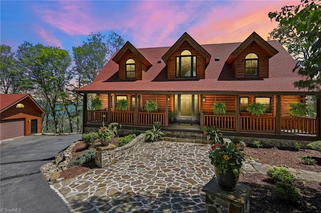 324 Sugar View Trl, Banner Elk, NC 28604 - view of front of home featuring a porch, a detached garage, an outbuilding, and roof with shingles