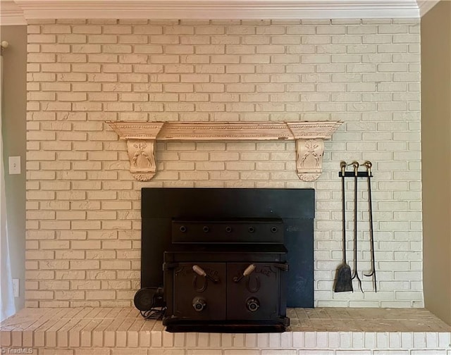 interior details featuring ornamental molding and a fireplace
