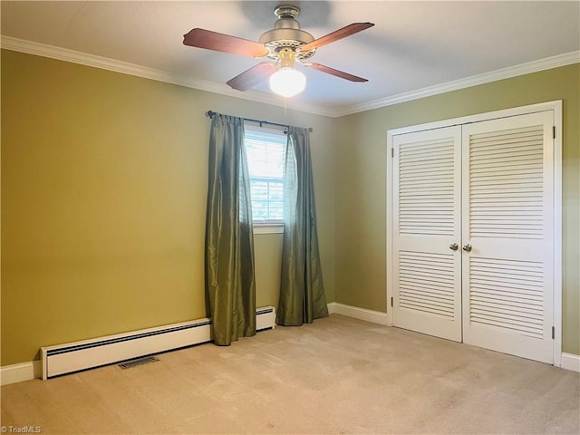 unfurnished bedroom with baseboards, ornamental molding, a closet, and light colored carpet