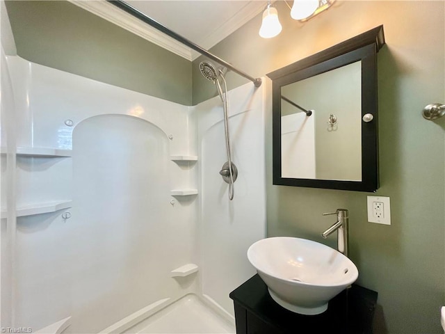 full bath featuring a shower, vanity, and ornamental molding