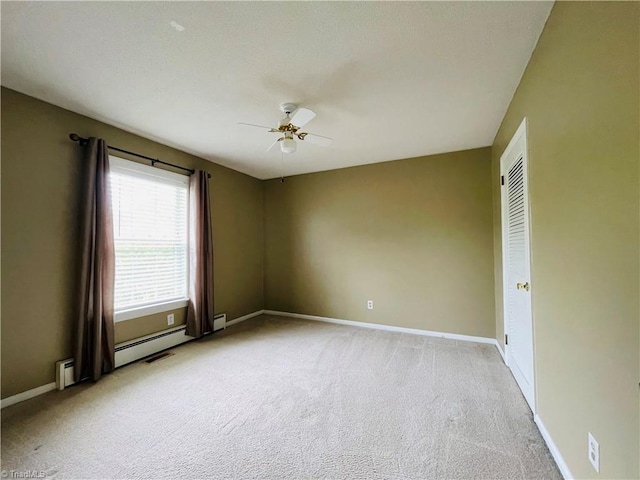 empty room featuring a ceiling fan, light colored carpet, and baseboards