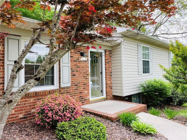 entrance to property with brick siding