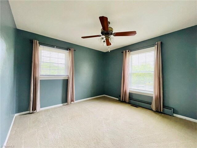 unfurnished room featuring baseboards, ceiling fan, carpet floors, and a baseboard radiator