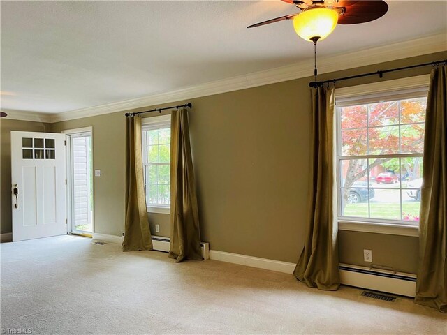 interior space with crown molding, light colored carpet, ceiling fan, plenty of natural light, and baseboard heating