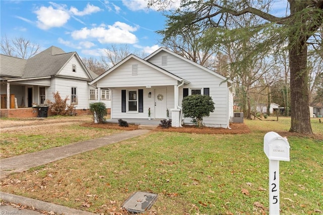 view of front of property with a porch and a front lawn