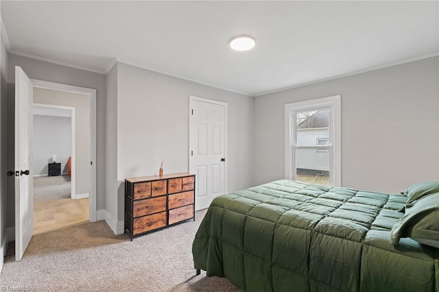 bedroom with crown molding and carpet floors