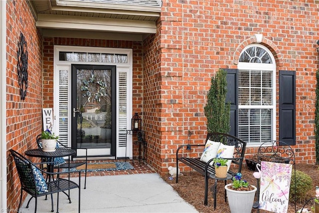 view of exterior entry with brick siding