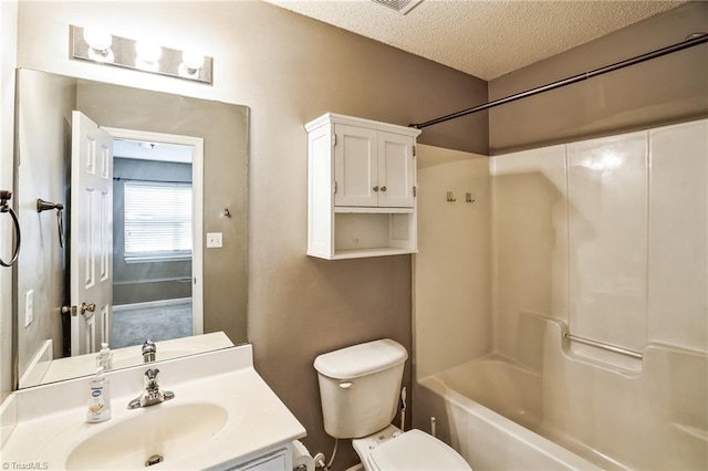 full bathroom featuring vanity, shower / tub combination, toilet, and a textured ceiling