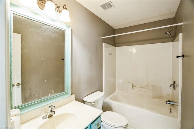 full bathroom with vanity, a textured ceiling, shower / washtub combination, and toilet