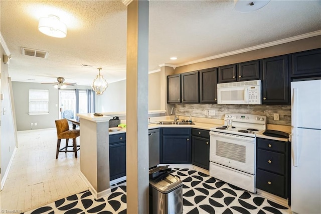 kitchen with sink, tasteful backsplash, crown molding, decorative light fixtures, and white appliances