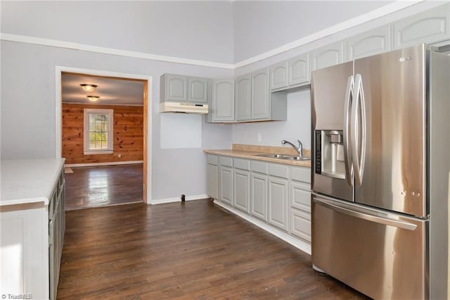 kitchen with wood walls, sink, dark hardwood / wood-style flooring, gray cabinetry, and stainless steel fridge with ice dispenser