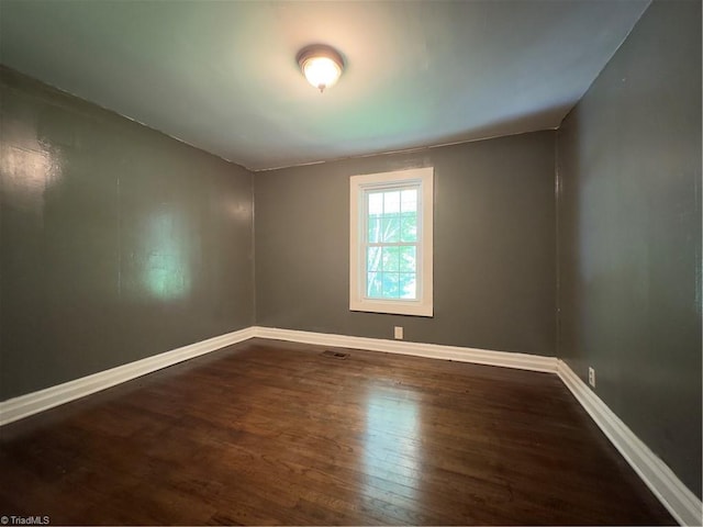 spare room featuring dark hardwood / wood-style flooring