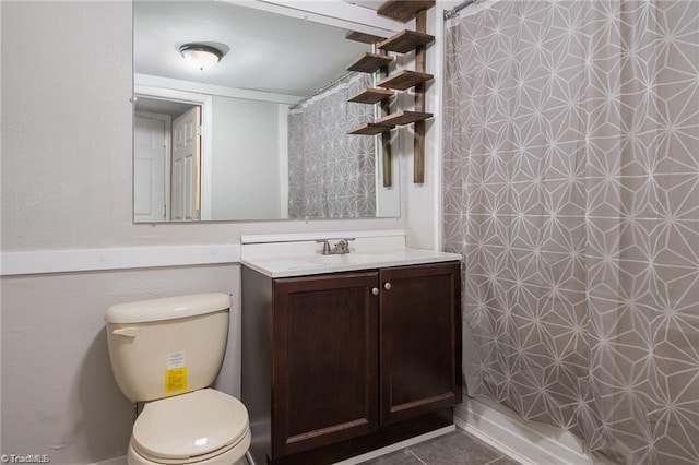 bathroom with tile patterned floors, vanity, and toilet