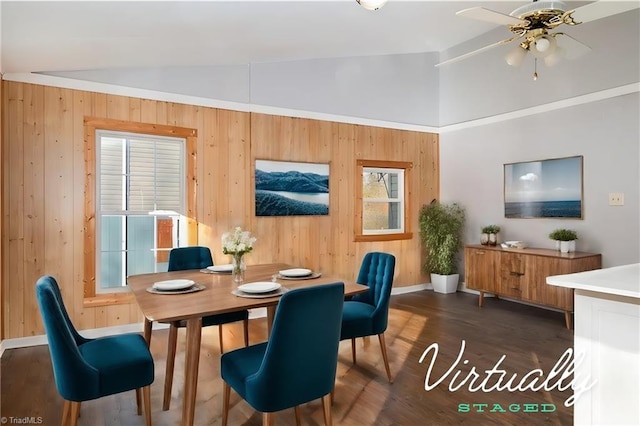 dining room featuring a wealth of natural light, lofted ceiling, and dark hardwood / wood-style floors