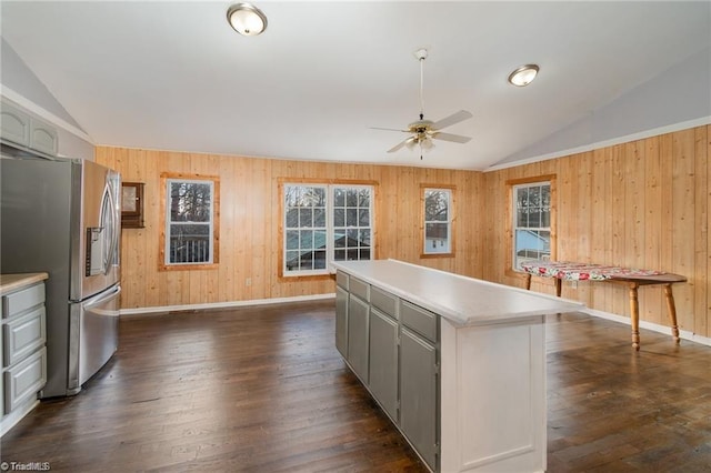 kitchen featuring vaulted ceiling, dark wood-type flooring, and stainless steel refrigerator with ice dispenser