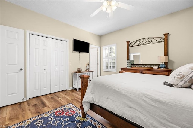 bedroom with ceiling fan, a closet, and light hardwood / wood-style floors