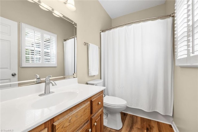 bathroom featuring hardwood / wood-style floors, vanity, toilet, and a shower with curtain