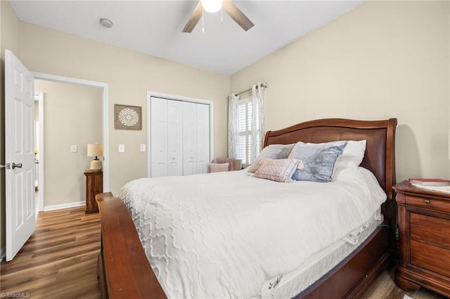 bedroom with a closet, ceiling fan, and dark hardwood / wood-style flooring