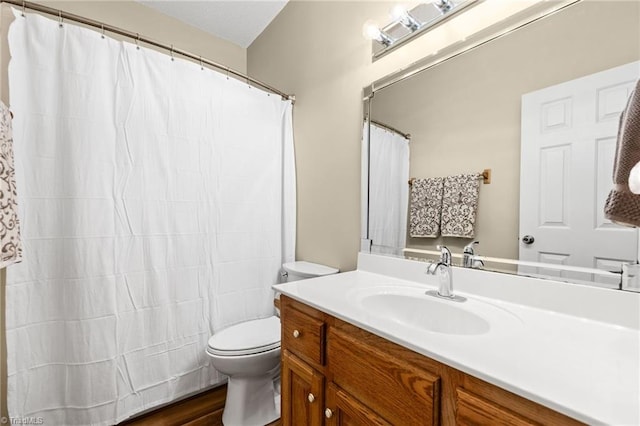 bathroom featuring hardwood / wood-style floors, vanity, toilet, and a shower with curtain