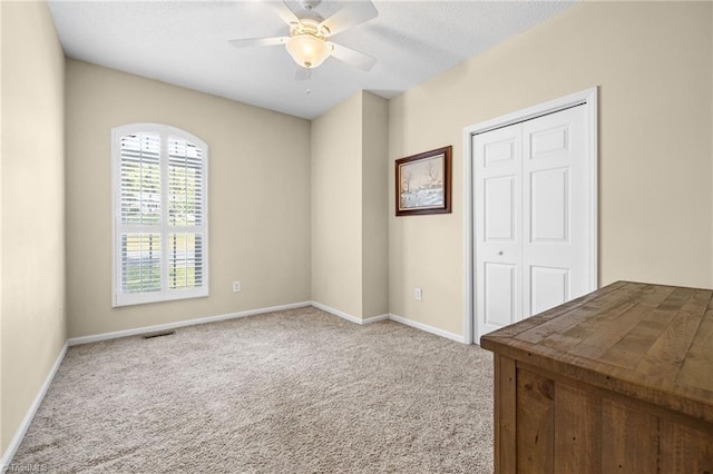 spare room with carpet and ceiling fan