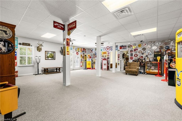 interior space with carpet floors and a paneled ceiling